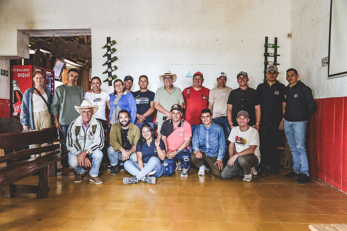 Las Perlitas coffee producers and sourcing team gathered indoors in Colombia